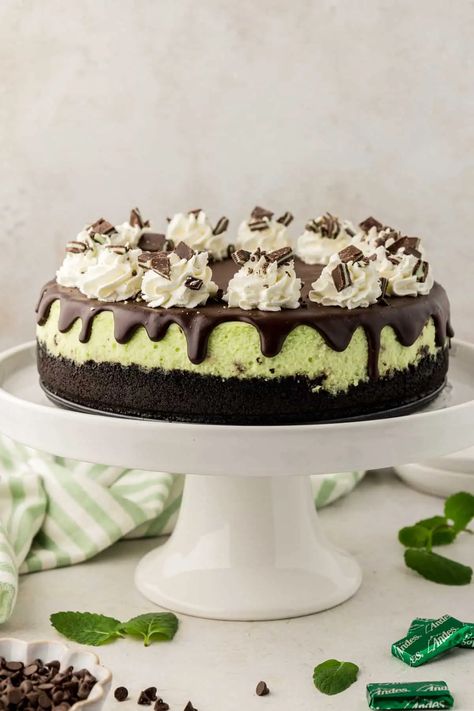 This chocolate mint cheesecake has a creamy mint cheesecake with a chocolate ganache topping, and an Oreo cookie crust! Made with peppermint extract, chocolate chips, and garnished with Andes candies, this cheesecake is bursting with mint and chocolate flavor. It's a great make ahead dessert! Wonderful recipe to make for Christmas, St. Patrick's Day or any time you need a make ahead dessert for guests. Andes Mint Cheesecake, Mint Chocolate Chip Cheesecake, Chocolate Mint Cheesecake, Green Cheesecake, Andes Candies, Chocolate Ganache Topping, Mint Chocolate Cheesecake, Mint And Chocolate, Mint Cheesecake