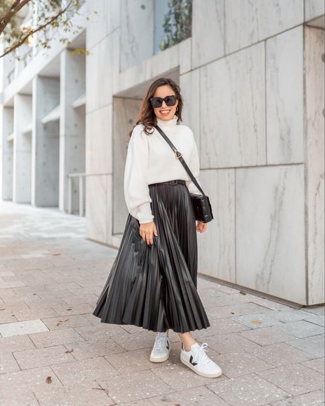 Black Faux Leather Midi Skirt is a closet staple! Love it paired with my Veja sneakers and a soft white sweater Pleated Leather Skirt Outfit, Black Skirt Winter, Leather Midi Skirt Outfit, Skirt White Sneakers, Faux Leather Skirt Outfit, Black Pleated Skirt Outfit, Pleated Skirt Fall, White Sneakers Outfit, Pleated Skirt Outfit