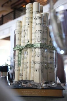 I want NON-floral centerpieces. LOVE this: rolled up sheet music. But Id add pearls around the outside and LARGE red bow/ribbon. - Click image to find more weddings posts Up Sheet Music, Music Centerpieces, Non Floral Centerpieces, Sheet Music Crafts, Music Themed Wedding, Tafel Decor, Music Crafts, Music Decor, Music Party