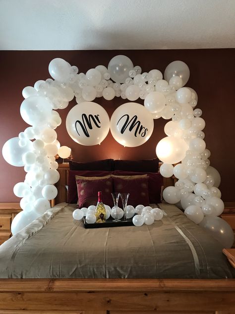 His and hers wedding balloon decorations are gorgeous even after the reception! Use creative balloon arch decorations for something unique, like your honeymoon bed. Complete with mini balloons with no helium for extra pop! Wedding Hotel Room, Mr And Mrs Balloons, Bridal Suite Decor, Honeymoon Rooms, Hotel Room Decoration, Bridal Room Decor, Romantic Hotel Rooms, Wedding Night Room Decorations, Romantic Room Surprise