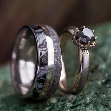 Share a dark, metallic style with this black diamond ring set! The black diamond engagement ring is made with 10k white gold and features a lotus flower-style setting adorned with sapphire accents. Meanwhile, the titanium wedding band’s white gold pinstripe unites the two rings with its matching meteorite inlay. Try something different with this space-inspired meteorite ring set! Ring 1: Black Diamond Engagement Ring (SKU 2503)Ring Width: 3.5 mmRing Sleeve: 10k White GoldRing Profile: RoundRing Black Diamond Ring Set, Diamond Ring Set, Black Diamond Ring Engagement, Engagement Ring White Gold, White Gold Wedding Rings, Black Diamond Ring, Morganite Engagement Ring, Diamond Ring Settings, White Gold Wedding