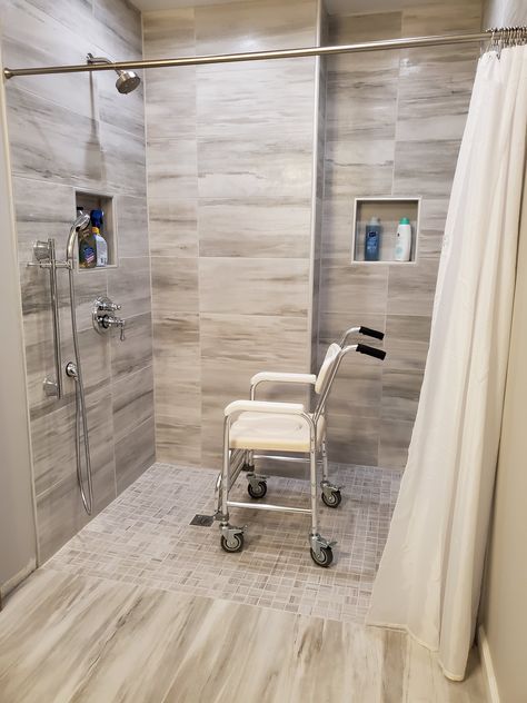 Built with accessibility in mind, this shower features a curbless entry, slide bar with handheld shower hose, and in wall-shower niches. The shower installation was done by Lifeway Mobility Chicagoland at a home in Naperville, IL. Shower For Handicapped, Wheel Chair Accessible Showers, Ada Home Ideas, Small Handicapped Bathroom Ideas, Handicapped Shower Ideas, Handicapped Bathroom Ideas, Ada Bathroom Design, Zero Entry Shower Ideas, Shower For Elderly