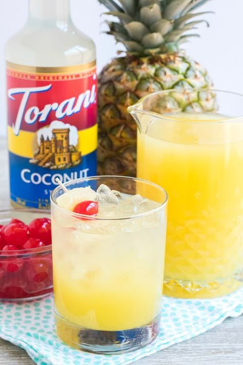 Pina Colada Rum Punch made with Torani Coconut Syrup. Serve this fan favorite cocktail for brunch (or any other time that seems right!) this Spring and Summer. It'll make you feel like you're on vacation - ignore the kids in the background Alcohol Punch, Torani Syrup Recipes, Torani Recipes, Pina Colada Rum, Italian Sodas, Sugar Free Coffee Syrup, Bread Booze Bacon, Torani Syrup, Lemon Juice Uses