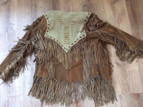 Vintage Fringed Jacket 1970's, 1980's Vintage Motorcycle Jacket Collarless and Native American Style with Beaded Breastplate Not sure if Wood or Bone beads Wide Suede Lacing Detail 2 tone Suede Snap Front Lined, the inside pockets may be an add on The size is an XL, but Please go by measurements taken laid flat seam to seam 23" shoulder to shoulder 22 1/2" armpit to armpit 26" sleeves 37 1/2" long from shoulder Excellent vintage Condition. Some dirt smudges on the back Coat is heavy, so shipping Bohemian Brown Outerwear For Rodeo, Beaded Breastplate, Vintage Fringe Jacket, Vintage Motorcycle Jacket, Western Ideas, Fringed Jacket, Carbon Copy, Vintage Fringe, Flat Seam