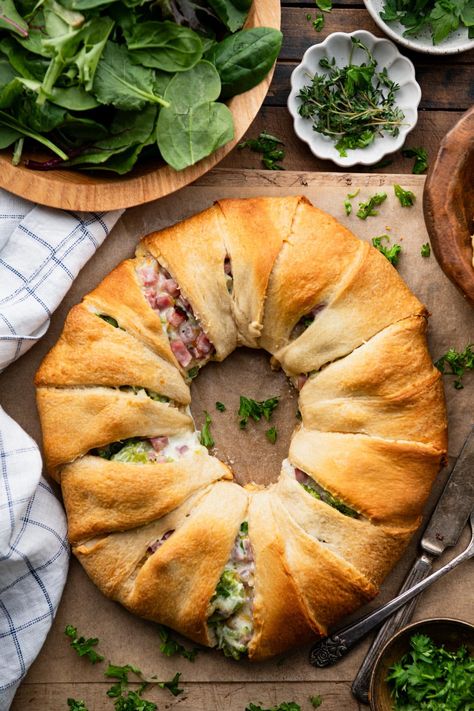 Ham and cheese crescent rolls bake in a ring for an easy-to-serve, easy-to-slice weeknight dinner or crowd-pleasing appetizer. The ham, cheddar, and broccoli crescent ring is flaky, golden brown, and stuffed with a creamy, cheesy, and flavorful filling. It's delicious alongside a simple salad, potato chips, or fresh fruit. Broccoli Ham Ring, Recipes With Crescent Rolls, Ham And Cheese Crescent Rolls, Ham And Cheese Crescent, Cheese Crescent Roll Recipes, Crescent Roll Bake, Salad Potato, Crescent Dough Sheet, Cheese Crescent Rolls