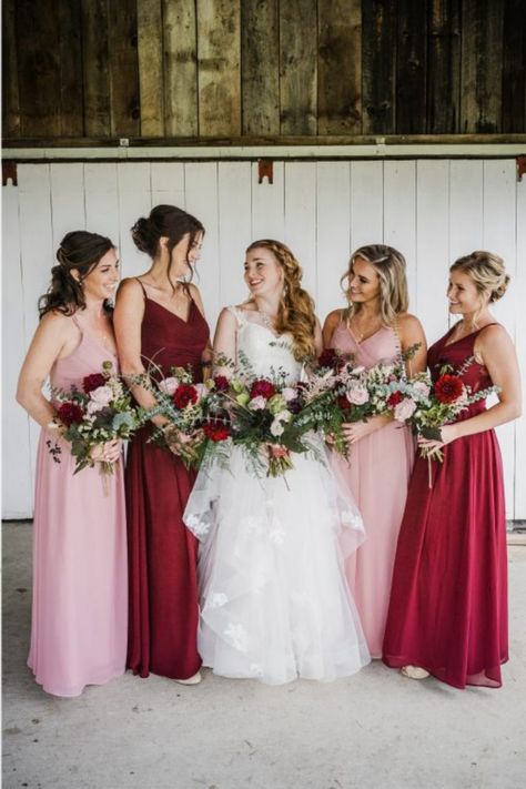 Bridesmaids wearing red and pink dresses in a rustic fall wedding. Magenta Pink Wedding Theme, Pink Red And White Wedding Bridesmaid Dresses, Red And Pink Wedding Bridesmaid Dresses, Pink Red Burgundy Wedding, Deep Red And Pink Wedding, Red And Blush Bridesmaid Dresses, Red And Pink Wedding Party, Pink And Red Wedding Groomsmen, Dusty Pink And Red Wedding