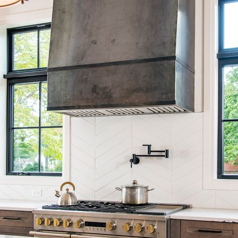 #Sundays in the #Kitchen New build details... Custom designed carbonized steel #RangeHood and #Chevron #Mosaic #backSplash! Gorgeous! Seldom does a range hood become the centerpiece, but in this kitchen, it’s all everyone is talking about. 🔥🔪👩‍🍳 #NewBuild #NashvilleInteriorDesigner #Architecture #InteriorDesign #KitchenBuild #kithcenNewBuild #HomeDesign #HomeRenovation #HomeDecor #Stove #ZigZagBackSplash #customHood #InstaHome #KithechenIsTheHeartofaHome #ovenHood #CustomKitchent Tall Range Hoods, Black Viking Range In Kitchen, Range Hood Steel, Steel Range Hood Ideas, Cement Range Hood, Concrete Look Range Hood, Metal Hood Vents Kitchen, Black Plaster Range Hood, Modern Oven Hood Ideas