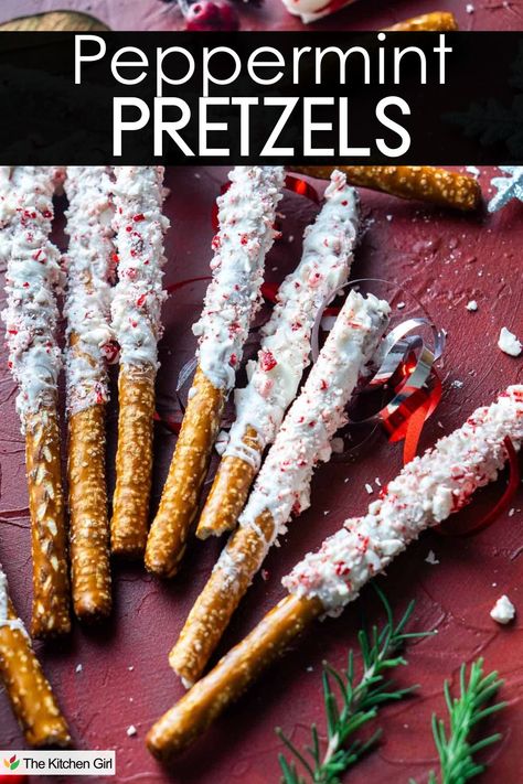 Close-up of pretzel sticks coated with white chocolate and sprinkled with crushed peppermint displayed on a festive red surface with ribbons and greenery. Text at the top reads Peppermint Pretzels. Candy Coated Pretzels Christmas, Covered Pretzels Christmas, Christmas Pretzel Rods, Pretzels Sticks, Peppermint Pretzels, Pretzel Rods Dipped, Chocolate Pretzels Recipe, Pretzels Christmas, Chocolate Covered Pretzels Christmas