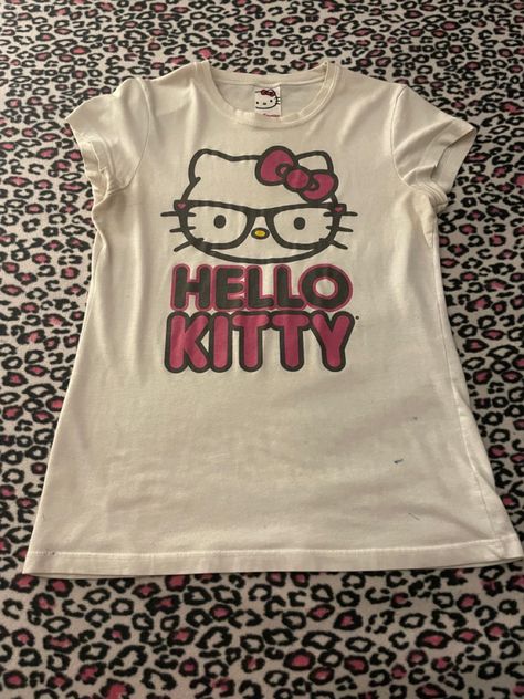 Rare-ish Mighty Fine nerd Hello Kitty shirt! Shows Hello Kitty with “nerd” glasses and her name in black and pink underneath her Hello Kitty Leavers Shirt, Hello Kitty Shirt Design, Pink Hello Kitty Graphic Tee, Hello Kitty T-shirt, Hello Kitty Fits Y2k, Hello Kitty Shirt Outfits, Hello Kitty Y2k Aesthetic, Shirts Hello Kitty, Nerd Hello Kitty