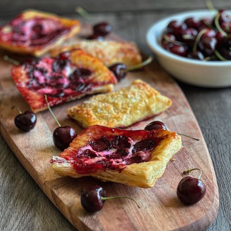 We have all heard of cherries and cheesecake, and cherry cheesecake, but what about cherry cheesecake upside-down pastries? This is our version of the viral pastry food trend, featuring delicious, sweet red cherries as the star of the show.  We simplify this recipe by using store-bought puff pastry dough that is ready to Upside Down Pastry Puff, Cheese Puff Pastry, Puff Pastry Tart, Puff Pastry Dough, Tart Dessert, Cheese Pairings, Cherry Cheesecake, Whipped Cream Cheese, Puff Pastry Recipes