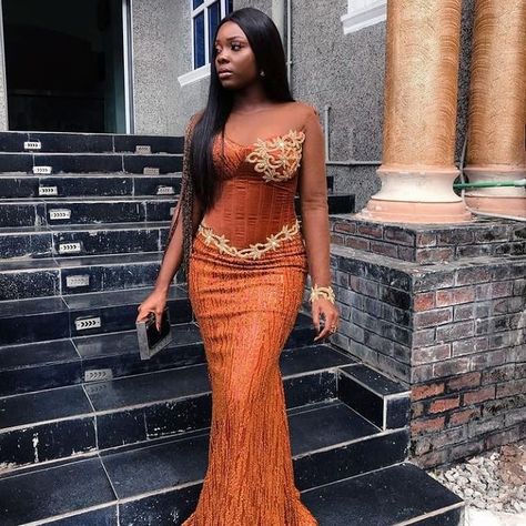 Latest and Best Aso Ebi Style 2021. - Ladeey Aso Ebi Corset Styles, Corset Aso Ebi Dress, Victoria Corset Aso Ebi Dress, Latest Asoebi Styles, Orange Aso Ebi Lace Styles, Ask Ebi Styles, Burnt Orange Lace Dress, Lace Gown Styles Aso Ebi, Orange Lace Dress