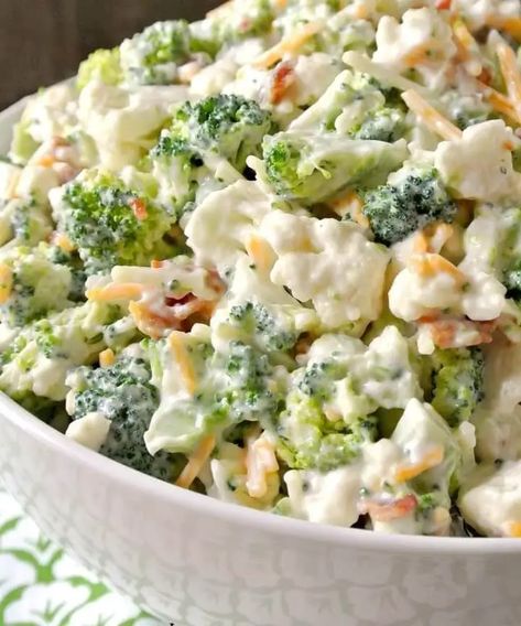 Broccoli Salad is a quick summer salad chock full of fresh crisp broccoli, dried cranberries, sunflower seeds, and bacon bits. It’s all tossed in a creamy homemade dressing.Since it’s best made ahead of time (and everyone raves over this recipe), it is the perfect potluck dish, great for any gathering or bbq.My family absolutely LOVES vegetables so I always serve fresh salads and this Broccoli Salad is one of our favorites! It’s so incredibly easy to make Since it’s best made ahead of time, it’s Loaded Broccoli Cauliflower Salad, Creamy Broccoli Salad Recipe, Keto Broccoli Salad, Low Carb Broccoli, Loaded Broccoli, Creamy Broccoli Salad, Broccoli Cauliflower Salad, Raw Cauliflower, Slow Cooker Ham