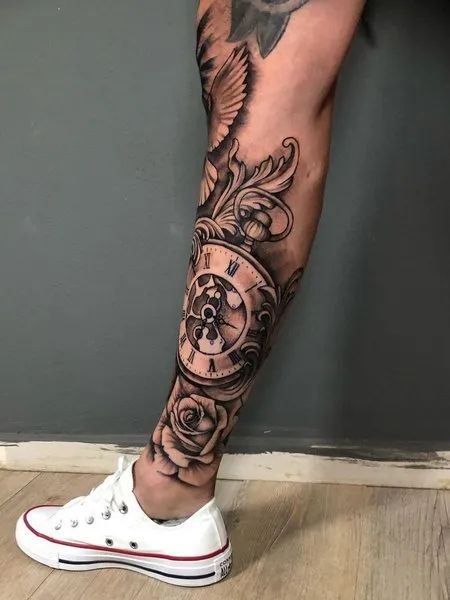 Clock Leg Tattoo Clock Tattoo Design For Men Leg, Men’s Shin Tattoo Ideas, Clock Leg Tattoo Men, Family Leg Tattoo Men, Bottom Leg Tattoo Men, Lower Leg Sleeve Tattoo Mens, Lower Leg Tattoo Sleeve, Men Shin Tattoo, Family Leg Tattoo