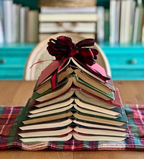 Two friends sent me the reel of a book tree like this so it was a must to recreate it with some old books I have and use it as a centerpiece in our dining room table. I love it! Have you decorated for Christmas yet? #jillhowelldesigns #booktree #bookstagram #bookdecor #booklover #bibliotree #falalalala Book Tablescape, Vintage Book Centerpiece, Book Centerpiece, Book Centerpieces, Book Christmas Tree, Book Tree, Tree Centerpieces, Two Friends, Snail Mail