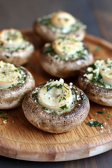 Garlic herb stuffed mushrooms displayed on a plate, showcasing delicious bite-sized appetizers that blend rich flavors and fresh herbs, ideal for elegant meals or casual gatherings. Elegant Starters For Dinner Party, Mushroom Appetizers Easy, Simple Starters For Dinner Party, Fancy Appetizers For Party Hors D'oeuvres, Fancy Hors D’oeuvres, Garlic Stuffed Mushrooms, Vegetarian Stuffed Mushrooms, Goat Cheese Stuffed Mushrooms, Gourmet Mushrooms