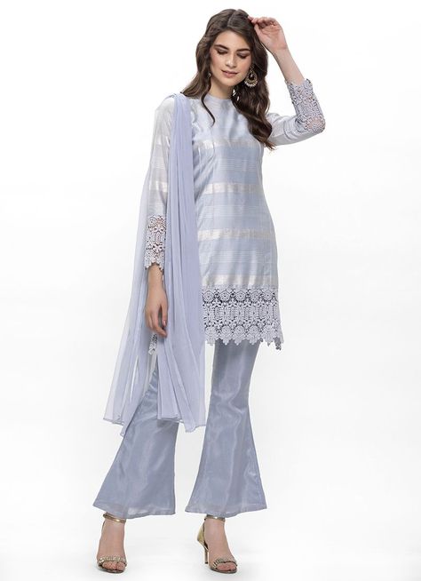 A lovely light blue lurex cotton slub kurta set is all you need to look fab this season. It consists of a shift dress with crew neck and crochet lace at top and full fitted sleeves hem. It is paired with matching dupion bell bottom trousers and light blue chiffon dupatta. Indian Clothing Brands, Bell Bottom Trousers, Ethnic Wear Indian, Fitted Sleeves, Chiffon Dupatta, Indian Clothing, Kurta Set, Bell Bottom, Dress Cuts