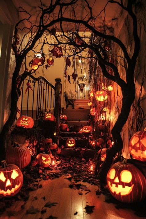 Dimly lit staircase decorated with glowing jack-o'-lanterns and hanging cobwebs for Halloween. Rental Friendly Halloween Decor, Large Halloween Decor, Decorate House For Halloween, Halloween Inside Decorations, Indoor Haunted House Ideas, Haunted House Decorations Indoor, Classy Halloween Decorations Indoor, Halloween Doorway Decorations, Halloween Decorations Indoor Ceiling