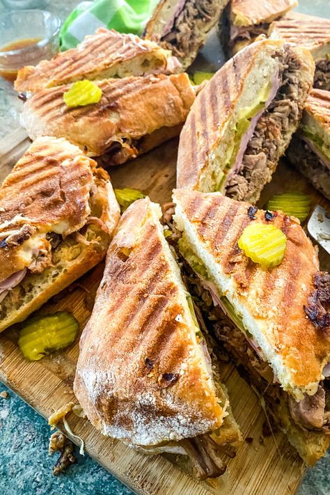 Shredded pork, thinly sliced ham, Swiss cheese, and dill pickle chips. Layer on loaves of airy ciabatta slathered with Dijon mustard. Crisp up in a panini press. Cuban Pulled Pork Sandwiches. #cubansandwich #cubano #pulledpork #sandwichrecipe #dinnerideas #panini Cuban Pork Sandwich, Cuban Pulled Pork, Cuban Sandwich Recipe, Cuban Sandwiches, Cuban Pork, Big Sandwich, Pulled Pork Sandwiches, Dill Pickle Chips, Pork Sandwiches