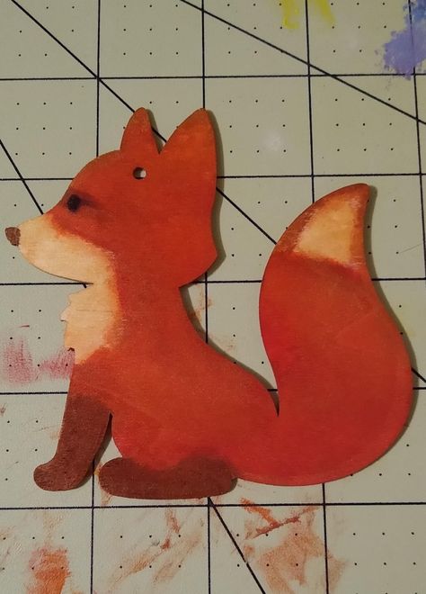 A wooden fox-shaped cutout painted to look like a red fox. Wooden Fox Decor, Dollar Tree Fox Craft, Wood Fox Ornament, Dollar Tree Wooden Fox Ornaments, Painted Fox Ornament, Dollar Tree Fox Cutout, Dollar Tree Wood Ornaments, Bazar Ideas, Fall Greetings