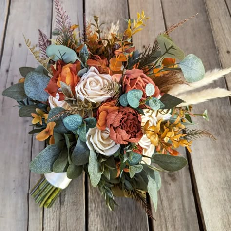 Absolutely stunning rust and cream wood flower bouquet. At Rose & Bee we specialize in creating custom one of a kind wood flower bouquets. Our bouquets make the perfect keepsake to remember your beautiful day! Remove the hassle of drying your flowers and go with Rose & Bee. #bridalbouquet #fallwedding #bride #weddingplanning Real Flower Wedding Bouquets, Boho Rust Wedding Bouquet, Fall Wildflower Bouquet Boho Wedding, Wedding Bouquets Wood Flowers, Rustic Bridal Bouquet Dried Flowers, Boho Wood Flower Bouquet, Wooden Flower Bouquet, Surprise Arizona, Sunflower Bridal Bouquet