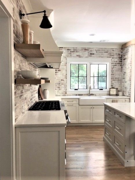 Subway Tile With Brick Accent, Cottage Above Cabinet Decor, White Cabinets Black Granite Brick Backsplash, French Country Kitchen Backsplash Ideas, White Wash Brick Backsplash Kitchen, Kitchen White Brick Backsplash, Brick Wall In Kitchen, Kitchen With Brick Backsplash, Kitchen With Brick Wall