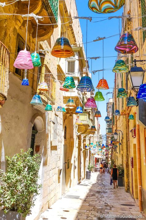 A narrow street in Valletta decorated with lanterns. Malta Italy, Malta Beaches, Malta Valletta, Mediterranean Travel, Valletta Malta, Malta Gozo, Malta Travel, Europe Holidays, Sweden Travel