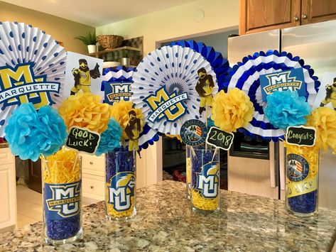 Graduation party centerpiece Marquette University College Graduation Party Ideas For Guys Decoration Center Pieces, Guy Graduation Centerpiece Ideas, College Centerpieces Table Decorations, Trunk Party Decorations, Trunk Party Ideas College, University Graduation Party, Tailgate Decor, Grad Party Centerpieces, College Gymnastics