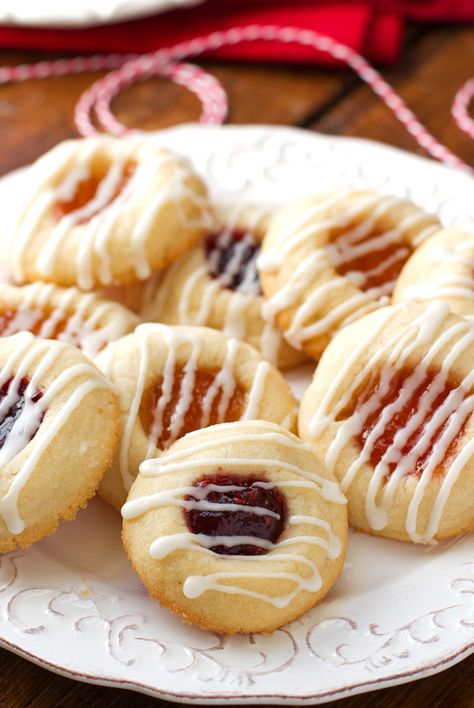 Easy 6 ingredient iced thumbprint cookies loaded with apricot or raspberry jam or jelly. Thimble cookies require little work. Shortbread cookie with jam. Thimble Cookies, Iced Thumbprint Cookies, Thumbprint Cookies With Icing, Best Thumbprint Cookies, Raspberry Thumbprint, Raspberry Thumbprint Cookies, Jam Thumbprint Cookies, Thumbprint Cookies Recipe, Buttery Shortbread Cookies