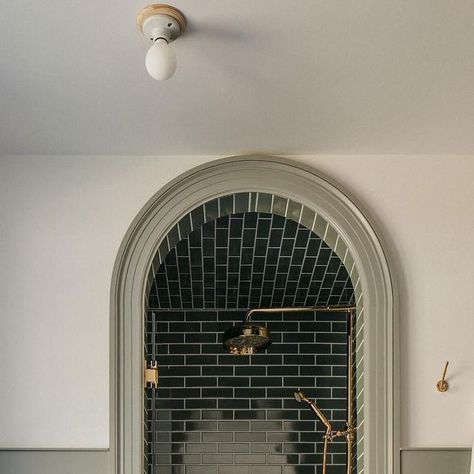 Alexander James Tile Studio on Instagram: "An arched opening creates a dream destination in this moody shower from @corey.lohmann.design. Matching the tone of the rich green tile to the millwork brings it full circle.⁣ ⁣ 𝗦𝗵𝗼𝗽 𝗢𝘂𝗿 𝗦𝗶𝗺𝗶𝗹𝗮𝗿 𝗦𝘁𝘆𝗹𝗲𝘀: Makoto Midori Green 2x10 Matte Ceramic 𝘭𝘪𝘯𝘬𝘦𝘥 𝘪𝘯 𝘣𝘪𝘰⁣ ⁣ ⁣⁣⁣⁣⁣⁣#AlexanderJames | Design: @corey.lohmann.design | Photography: @margaretrajic⁣ ⁣ #tile #ceramictile #tilestyle #lonnyliving #interiordesign #homerenovation #interior123 #bhilivebeautifully" Green Subway Tile, Porcelain Wall Tile, Stunning Bathrooms, December 23, Green Tile, Green Bathroom, Traditional Modern, Beautiful Bathrooms, Amazing Bathrooms