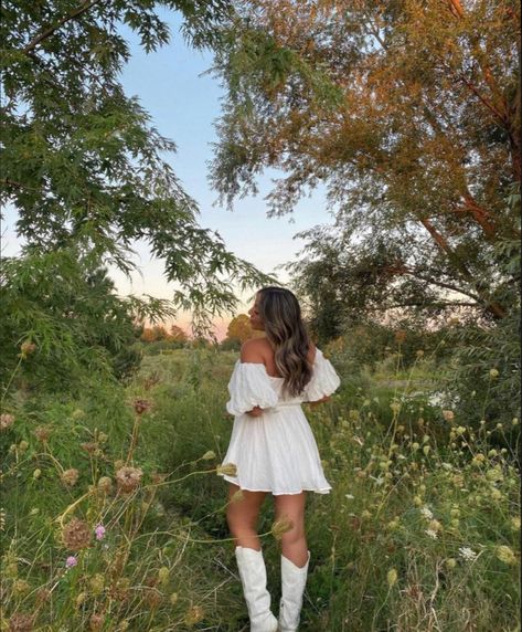 White Dress Country Photoshoot, Short Flowy Dress With Cowboy Boots, White Cowboy Boots Wedding Dress, Country Outfit White Boots, Outfits With White Cowgirl Boots Summer, Sundress And Boots Outfit, Senior Pictures With Cowboy Boots, White Dress With White Cowboy Boots, Plus Size White Cowboy Boots Outfit