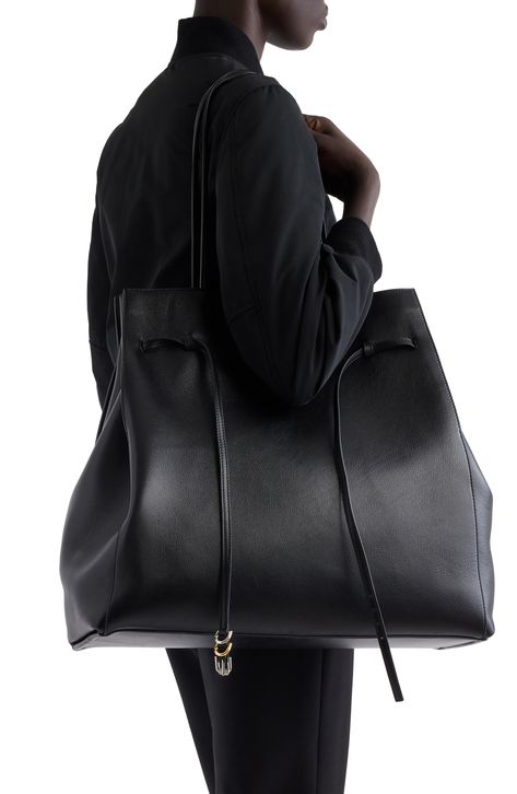 Spacious and sleek, this calfskin-leather tote is elegantly threaded with a buckled belt along the top. Open top Shoulder straps Lined Leather Made in Italy Designer Handbags Big Bag Street Style, Classic With An Edge Style, Big Designer Bags, Black Leather Bag, Black Designer Bags, Classy Purses, Givenchy Bag, Carryall Tote, Large Leather Tote Bag