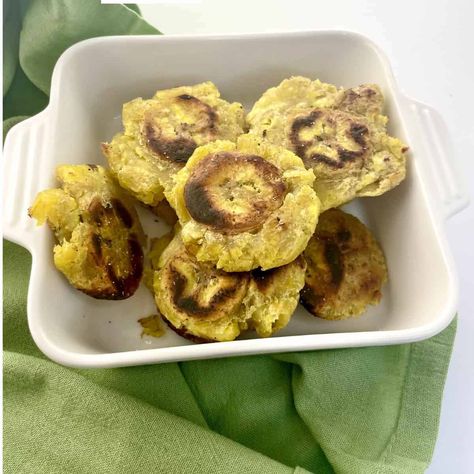 Cuban fried plantains are a savory side dish served with many Latin American meals. The golden crispy flattened discs open to a soft starchy interior. The texture and flavor is similar to a baked potato. Why You Will Love This Recipe Plantains are a fantastic side dish. Fried when green they make amazing 'chips' called tostones to serve with Latin and Latin influenced dishes. Cuban Plantains, American Meals, Mojo Sauce, Cuban Chicken, Fried Plantains, Frozen Dessert Recipe, Lime Salt, Lime Rice, Cilantro Lime Rice