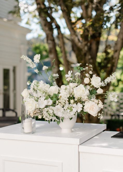 White Bar Arrangement, Bar Arrangement Wedding, Flowers On Bar Wedding, Wedding Bar Floral Arrangements, Long Table White Flowers, Organic White Wedding Florals, Wedding Bar Flowers White, Elevated Floral Centerpieces White, Sweetheart Table Flowers