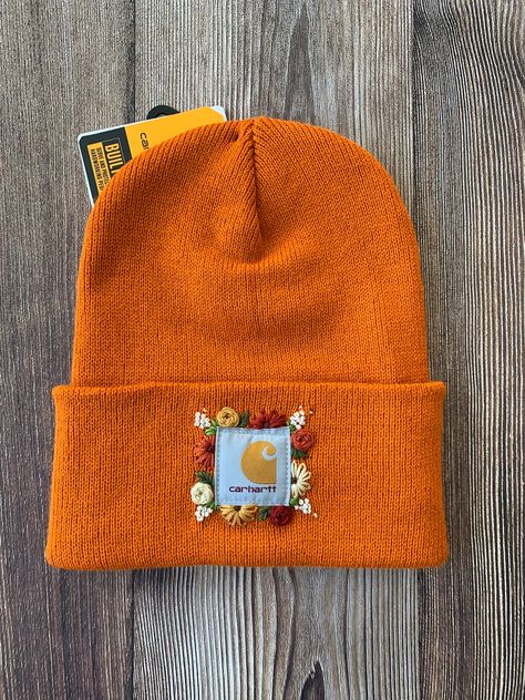 -Authentic Carhartt Knit Cuffed Beanie in the color Marmalade -Size Adult -100% Acrylic  Stand out in the crowd with this tried and true Carhartt beanie embellished with a whimsical hand embroidered floral design. Free-hand design created by me! How To Embroider Flowers On Carhartt Hat, Cathartic Hat Embroidered, Hat Hand Embroidery, Embroidered Beanie Floral, Carhart Beanies Embroidered, Embroidered Carhartt Beanie Diy, Cathartic Beanie Embroidered, Hand Embroidered Carhartt Beanie, Embroidered Carhartt Hat