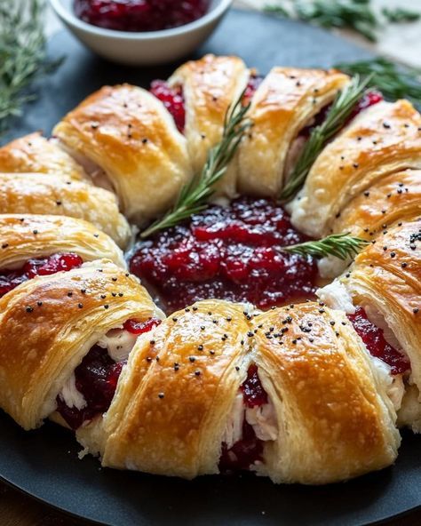 ￼ Savory Turkey and Cranberry Crescent Ring Ingredients: 1 tube crescent rolls 4 oz chive and onion cream cheese, softened 1 1/2 tbsp Dijon mustard 3 tsp finely chopped fresh rosemary or thyme, divided 2 cups shredded Gruyere cheese, divided 1 lb thinly sliced turkey (leftover or deli turkey) 1 (14 oz) can whole berry cranberry sauce 2 tbsp butter, melted 1/2 tsp poppy seeds 1/2 tsp granulated garlic 1/4 tsp salt (adjust to taste) Instructions: Preheat Oven and Prepare Pan: Preheat the oven to 375°F (190°C). Line a large baking sheet with parchment paper or a silicone baking mat. Prepare Crescent Rolls: Separate the crescent rolls and arrange them on the parchment paper in a circle with the widest portion on the inside and the edges overlapping. Prepare Filling: In a small bowl, whisk toge Chive And Onion Cream Cheese, Whole Berry Cranberry Sauce, Turkey And Cranberry, Cranberry Turkey, Granulated Garlic, Crescent Recipes, Crescent Ring, Easy Lunch Ideas, Deli Turkey