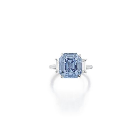 Exquisite Fancy Vivid Blue Diamond and Diamond Ring Set with an emerald-cut Fancy Vivid Blue diamond weighing 5.69 carats, flanked by baguette diamonds, size 5¼. Natural Blue Diamond, Colored Diamond Jewelry, Diamond Bracelet Design, Blue Diamond Ring, International Jewelry, Baguette Diamonds, Diamond Ring Settings, Fine Jewels, Engagement Ring Wedding Band