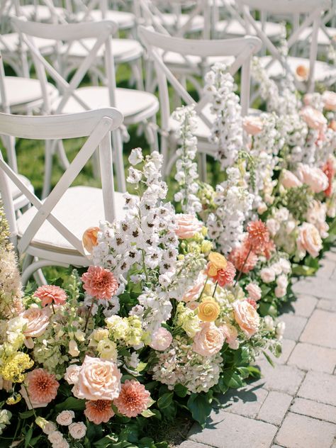 Coral dahlia, pink peach rose, peach foxglove, green hydrangea, white delphinium, eremurus, yellow yarrow, blush spray rose, peach lisianthus ceremony aisle floral hedge Peach Yellow Green Wedding, Peach Foxglove, Wedding Ceremony Aisle Flowers, Floral Hedge, Ceremony Aisle Flowers, Light Yellow Weddings, Ceremony Flowers Aisle, Coral Dahlia, Yellow Yarrow