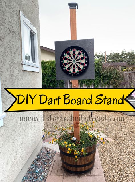 Make your own stand for a dart board. Visit www.itstartedwithtoast for step by step instructions with photos. Diy Dart Board Backing Outdoor, Mobile Dart Board Stand, Dart Board Outside, Free Standing Dart Board Stand Diy, Outdoor Dart Board Stand, Diy Outdoor Dart Board Stand, Dart Board Stand Diy, Portable Dart Board Stand Diy, Backyard Dart Board Ideas