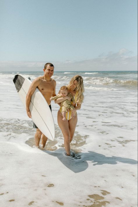 California family walks along the beach carrying their baby and surfboard Surf Family Photos, Family Surfing Photos, Surf Photoshoot, Surf Family, Surfer Couple, Beach Family Photoshoot, Baby Surf, Xmas Pics, Fun Family Photos