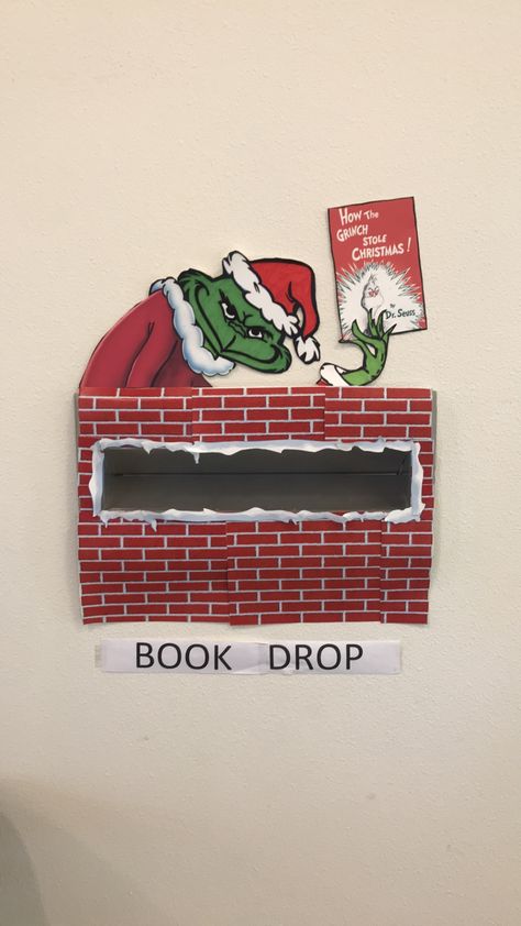 Grinch book drop Library Book Displays December, Grinch Library Decorations, Christmas Decor Ideas For Library, Library Book Return Box Cute Ideas, Library Book Drop Box Ideas, Winter Holiday Library Displays, Book Drop Decoration, Grinch Library Bulletin Boards, Library Winter Decorations