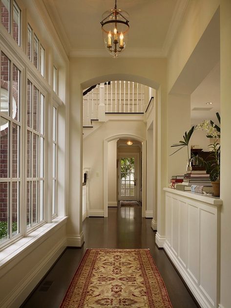 A corridor leading into a traditional foyer features glass lantern over red and gold Persian rug layered over hardwood floors. Ideas Of Living Room, Window Design Ideas, Traditional Foyer, Pass Through Window, Arched Doorway, Home Exteriors, Family Ideas, Dream House Rooms, Glass Lantern