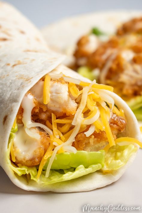 Air fryer snack wrap filled with breaded chicken, romaine lettuce, shredded Cheddar Jack cheese, and ranch dressing on a light gray plate. Crispy Chicken Lunch Ideas, Mcdonald’s Crispy Chicken Wrap, Mc Donalds Chicken Wrap, Crispy Chicken Snack Wraps, Popcorn Chicken Wrap, Crispy Wraps Recipes, Mcdonalds Crispy Chicken Snack Wrap, Chicken Tender Tortilla Wrap, Snack Wraps Chicken