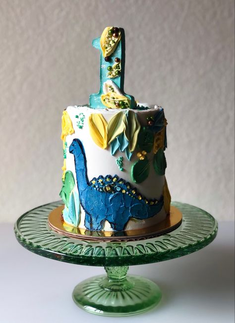 Dinosaur first birthday cake with blue buttercream painted dino and number 1 topper Buttercream Dinosaur Cake, Blue Dinosaur Cake, Dino Smash Cake, Dinosaur First Birthday Cake, Dinosaur Smash Cake, Toddler Birthday Party Themes, Artistic Cake, Dino Birthday Cake, Dinosaur Cakes