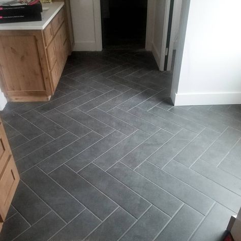 Herringbone bathroom tile Black Floor Tile Laundry Room, Slate Grey Bathroom Tile, Black Herringbone Tile Floor Entryway, Slate Herringbone Tile Floor Bathroom, Farmhouse Kitchen With Tile Floor, Kitchen Ideas With Tile Floors, Dark Bathroom Floor Tile Ideas, Herringbone Tile Floor Mudroom, Bathroom Floor Tile Ideas 2024