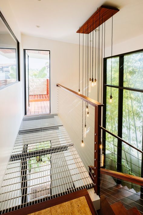 Photo 10 of 13 in This Gold Medalist Racer’s Home Takes Garage Design to the Next Level - Dwell Railing Wood, Eclectic Mugs, Atrium Windows, Blonde Flooring, Staircase Metal, Newport Beach Homes, Metal Railing, Wood Railing, Open Staircase