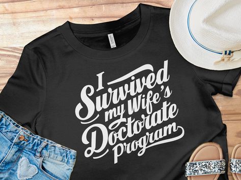 Celebrate the monumental achievement of your spouse completing her doctoral journey with this humorous and lighthearted T-shirt.

#graduation2024
#FinishEDD
#PhinisheD
#PHD
#EDD
#graduationcapdesigns
#graduationpartyideas
#graduationgiftideas
#graduationoutfitideas Doctorate Party, Phinished Phd, Doctorate Graduation, Phd Gifts, Graduation Cap Designs, Doctorate, Graduation Parties, Graduation Outfit, I Survived