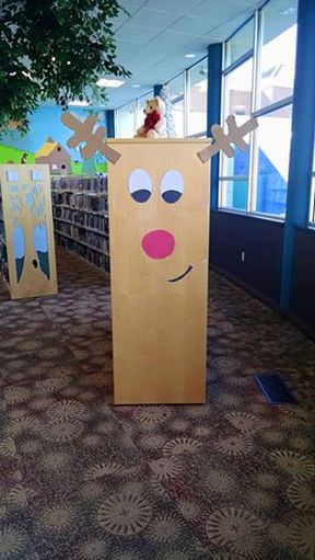 Christmas Decor Ideas In Library, Christmas Decor Ideas For Library, Reading Christmas Bulletin Boards, Christmas Decorations For Library, School Library Christmas Decorations, Library Drop Box Ideas, Library Holiday Decorations, Library Winter Decorations, Christmas Library Door Ideas