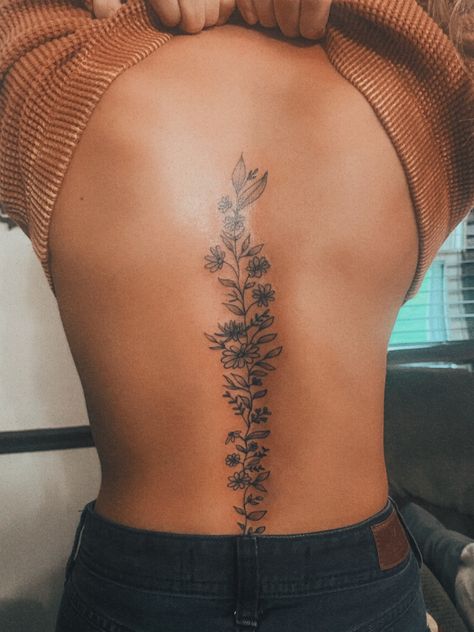 Flower Spine Tattoo Womens Spine Coverup Tattoos For Women, Wildflower Tattoo On Spine, Floral Spine Tattoo Black Women, Back Floral Tattoo Spine, Feminine Spine Tattoos Butterfly, Sun Flower Spine Tattoo, Spine Stencil Tattoo, Jasmine Flower Spine Tattoo, Sick Spine Tattoos