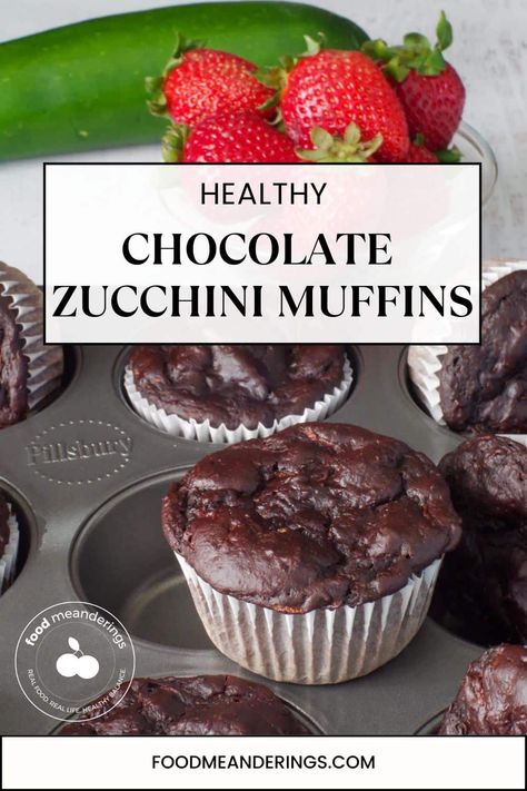 Healthy Chocolate Zucchini Muffins in a muffin tin , with one on top and strawberries and a zucchini in the background Healthy Chocolate Zucchini Muffins, Muffins Zucchini, Zucchini Healthy, Double Chocolate Zucchini Muffins, Zucchini Cupcakes, Zucchini Muffin, Chocolate Zucchini Muffins, Resepi Biskut, Cupcakes Recipes