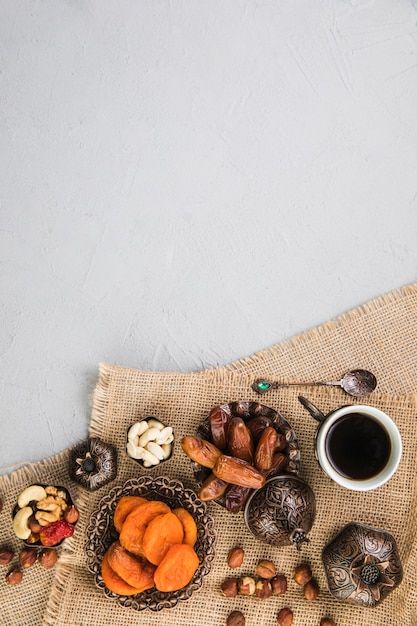 Coffee cup with dried fruits and nuts | Premium Photo #Freepik #photo #dates-fruit #dates #flat-lay #table-flatlay Plats Ramadan, Coffee Shop Photography, Photo Coffee, Ramadan Background, Floral Cards Design, Fruit Wallpaper, Food Photography Tips, Fruit Photography, Fast Dinners